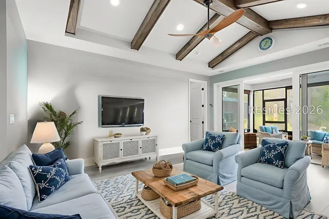 Living room with exposed beam ceiling at 1217 St. Somewhere Drive