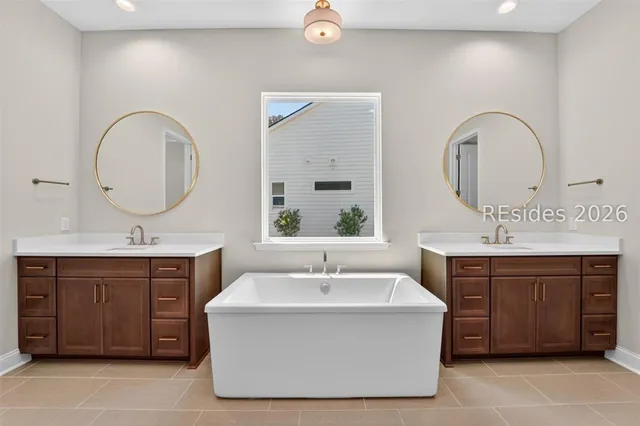 Double vanity in the primary bathroom at 1628 Laurel Oak Avenue
