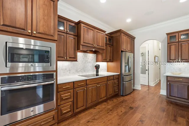 Kitchen with wood cabinetry and stainless appliances at 165 Topside E