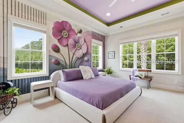 Primary bedroom with tray ceiling at 165 Topside E
