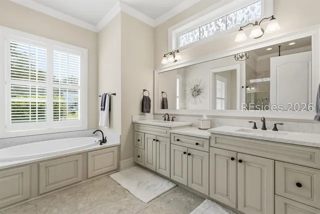 Primary bathroom with double vanity and soaking tub at 165 Topside E
