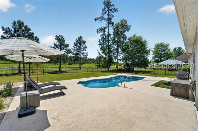 Pool deck and patio seating at 246 Laurel Oak Avenue