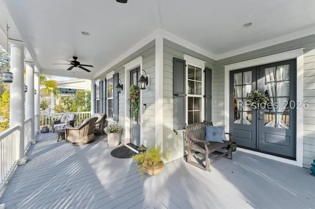 Full-width front porch with seating overlooking the pond at 5 Caspian Lane